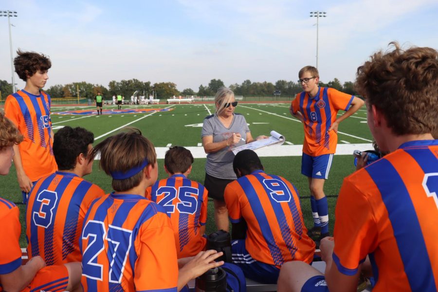 Coach+Swanson+gives+her+team+an+encouraging+pep+talk+at+halftime.