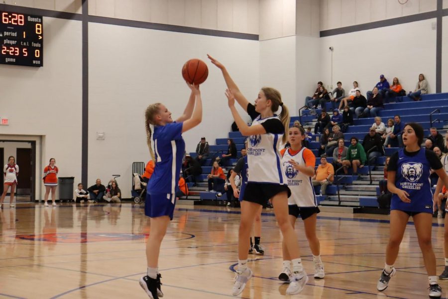 Emma Wilke attempts to block Sydney VanGundys shot at the Orange and Blue game.  