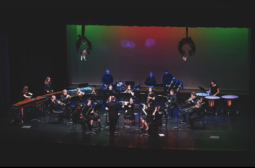 Presenting the piece, Santa the Barbarian, the NPHS Concert Band plays in front of a colored background lit accordingly to the festivity of the holiday season.