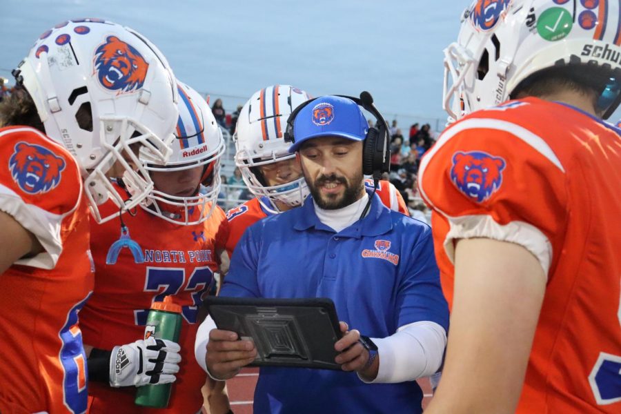 Coach Zangriles coaches up his offense as they prepare for the next drive.