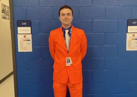 Mr. Matteoni wears his orange suit to show his school spirit.