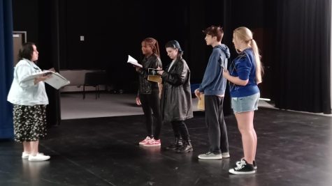 Mariah Robinson (24), Zan Houston (25), Tyson Swetnam (25) and Madison Anderson (26) are being taught their blocking for the musical number “D.O.A” by Ms. Abigail Menneses- Delcompare (Ms. Abby). 
