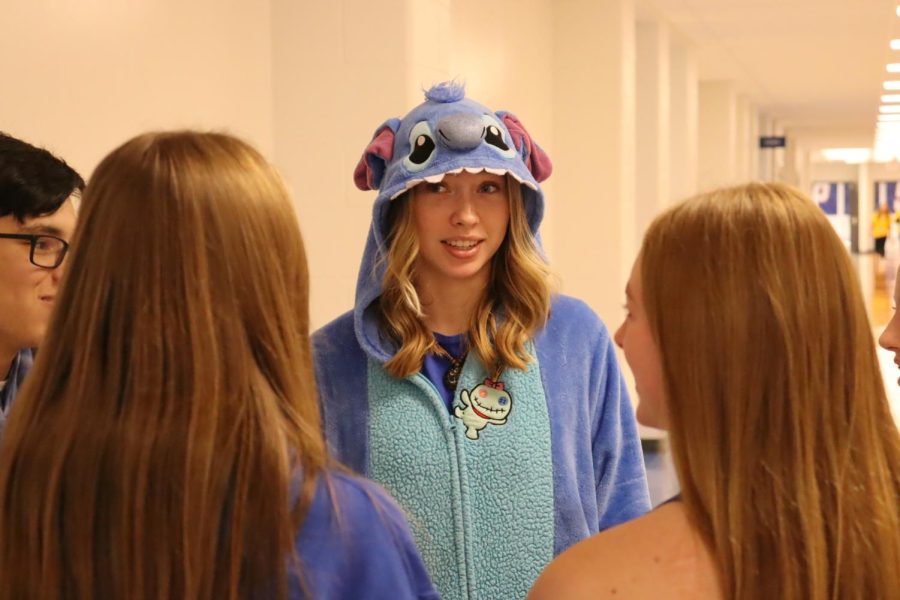 Iris Swafford (25) dresses up in her school colors with two of her friends, Faith Jones and Travis Doan. They all wore the same Stitch PJs. I had the PJs a year ago, and then Travis and Faith decided at the last minute to go buy some so we could match, Swafford said.