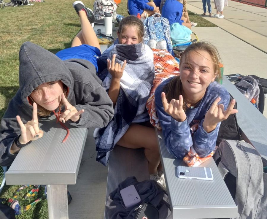 Meg Zumwalt ('23), Braelyn Traeger (‘25) and Olivia Stenberg (‘25)
take some break time before the tournament on the first day of the GAC tournament. 


