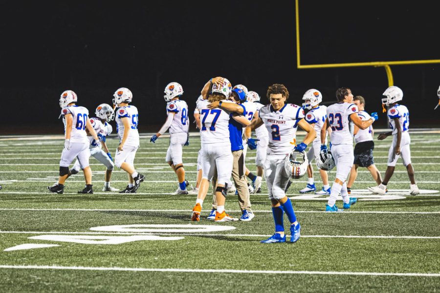 Carter Bridell (25) hugs head Coach Zangriles after the victory against Fort Zumwalt East.