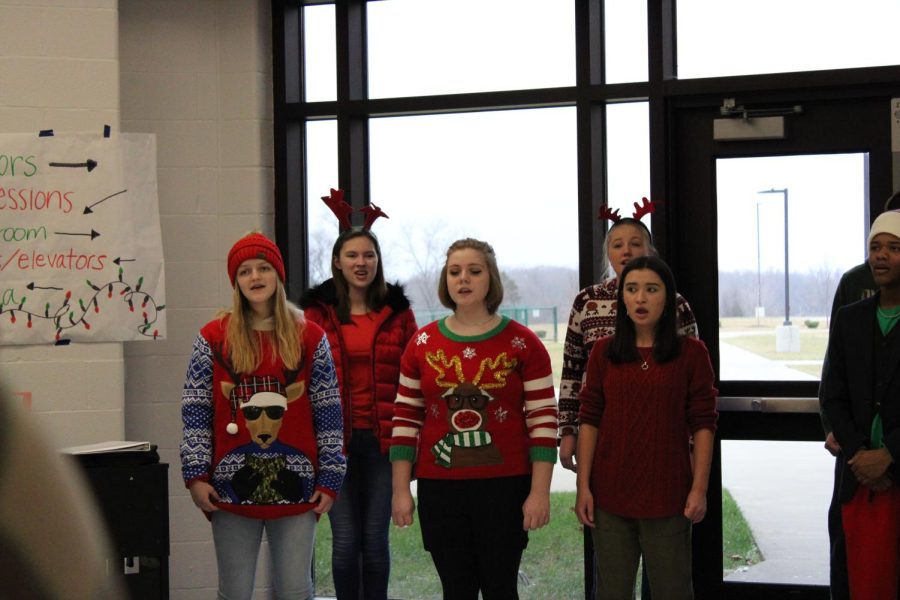 Sydney Vangundy (25) and the choir sing at the Holiday Market upon Santas arrival.