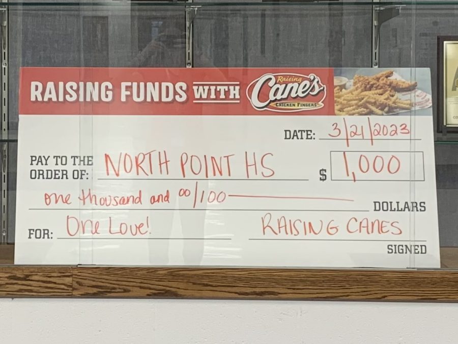 On opening day of Raising Canes North Point was presented with a $1,000 check.