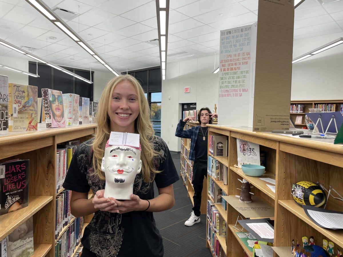 Iris Swafford (25) made her exhibit interactive. She claimed that we are an open book waiting to be created and put a notebook on her mannequin head and asked students to write in the book. She also left permanent markers for people to draw directly on the head.