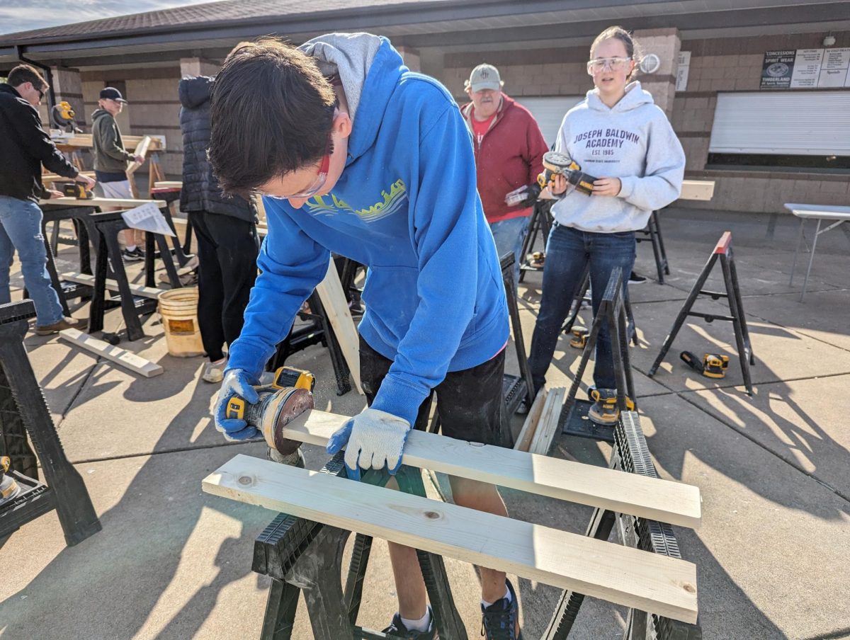 Students from our school joined other high schools to make beds for kids in need.