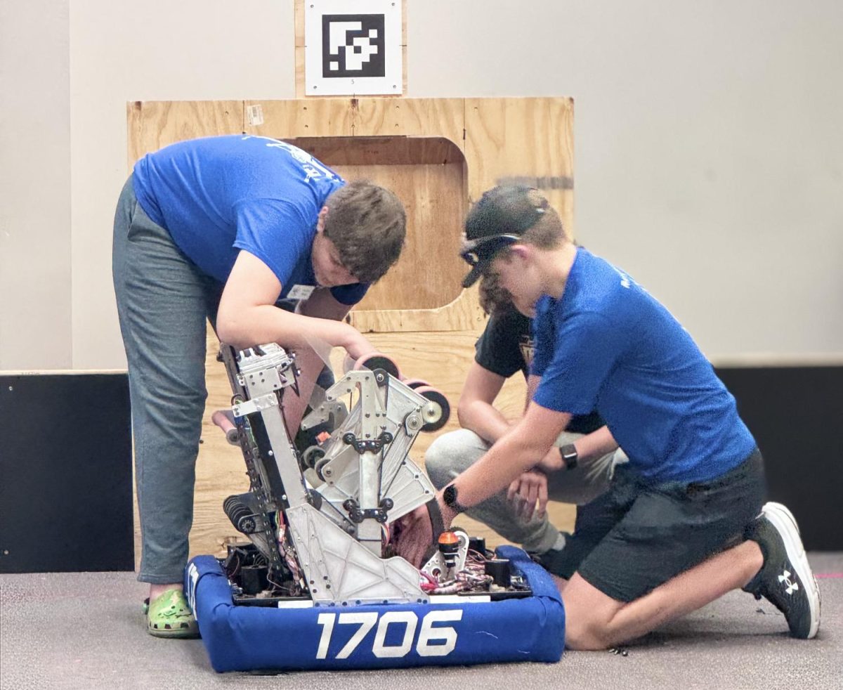 Peyton Meek ('27) works with a student from Liberty on a robot that will be in all of the competitions.