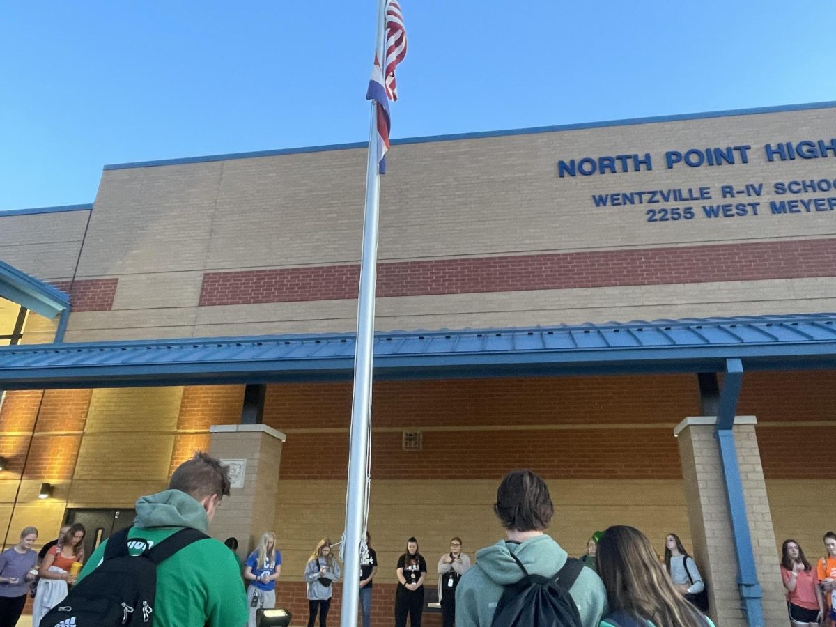 Students gathered around the flagpole outside to pray and worship.