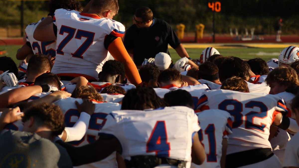 The team gets ready for their gamne with a team huddle.