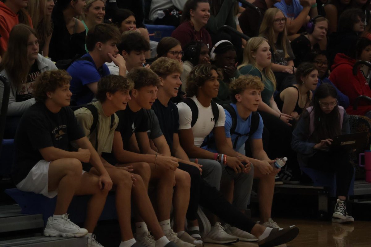 The students at the pep rally awaited the announcement of the HOCO theme.
