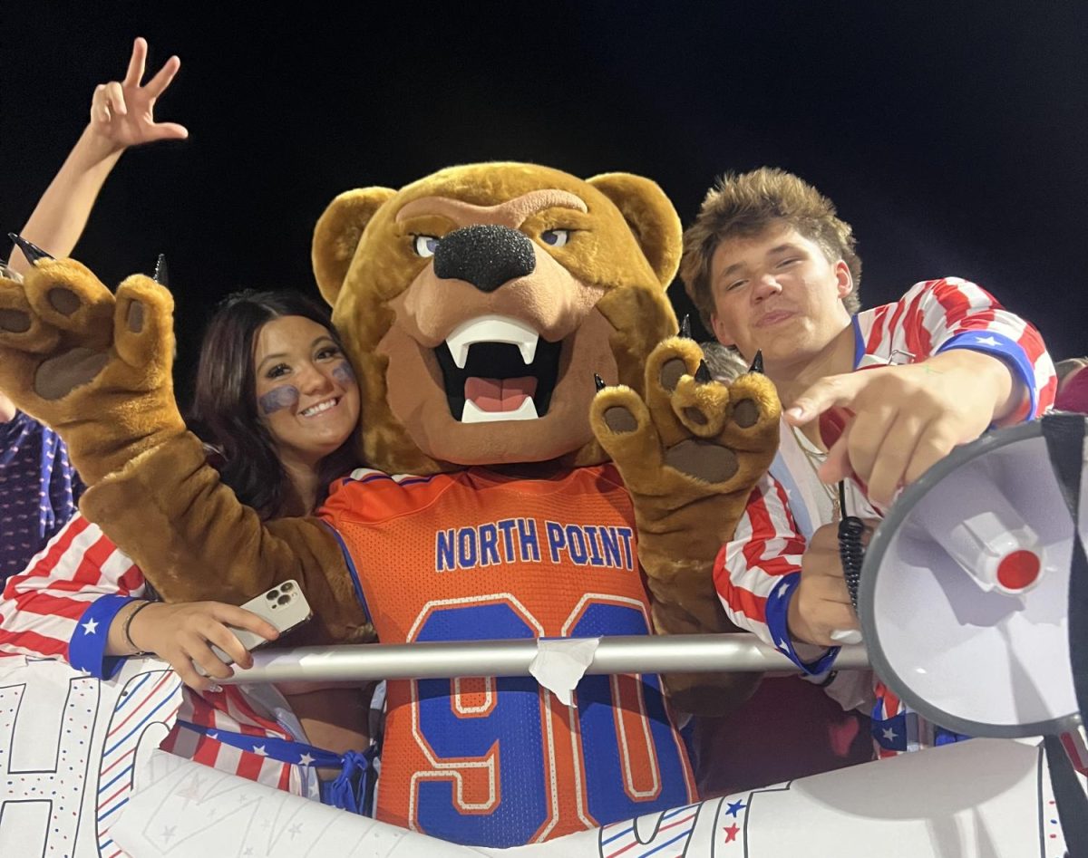 As the student section cheers, the new Grizzly Mascot reveals his face.