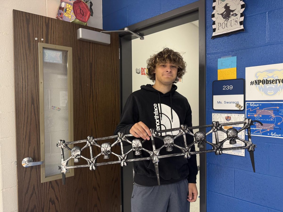 Dylan Richards ('26) holding up a spooky item.