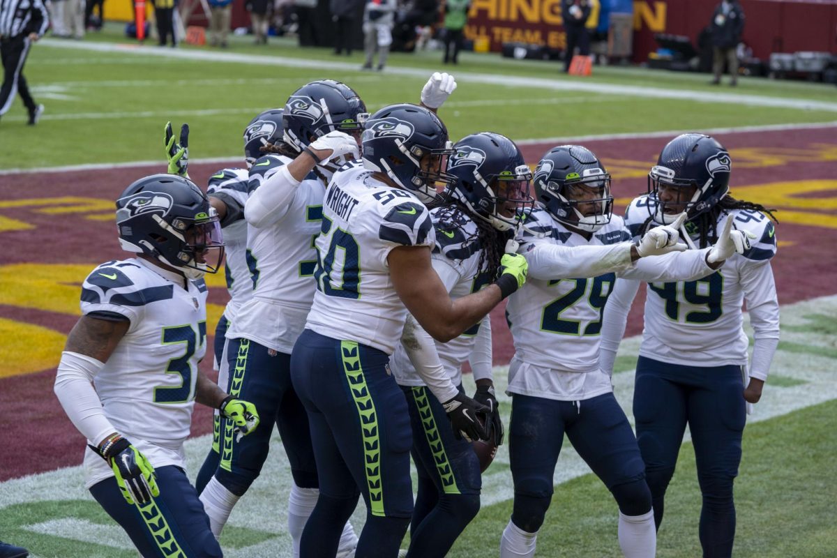 The Seattle Seahawks celebrating after a touchdown against the Washington Commanders. The Seahawks are set to face the New England Patriots in Super Bowl LX.